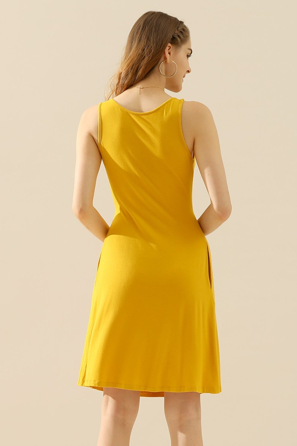 Yellow round neck ruched sleeveless dress with pockets, featuring a basic style, highly stretchy fabric, and opaque finish.