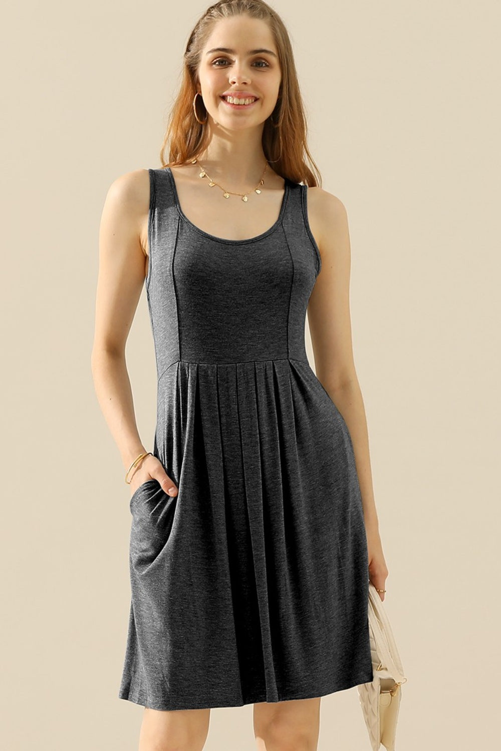 Woman wearing a round neck ruched sleeveless dress with pockets, basic style, highly stretchy fabric, perfect for casual wear.