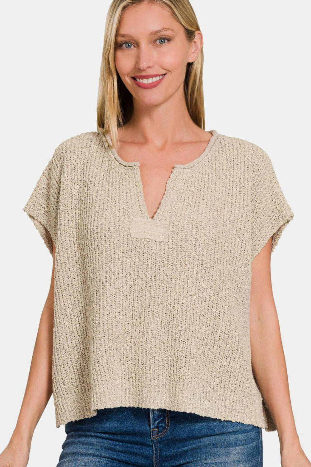 Chic short sleeve side slit sweater in lightweight knit, perfect for layering. Effortlessly stylish with jeans or dress pants.