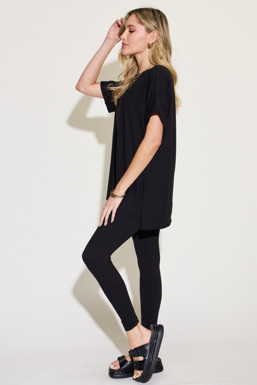 Woman in black short sleeve slit t-shirt and leggings lounge set, perfect for versatile all-day wear and errands.