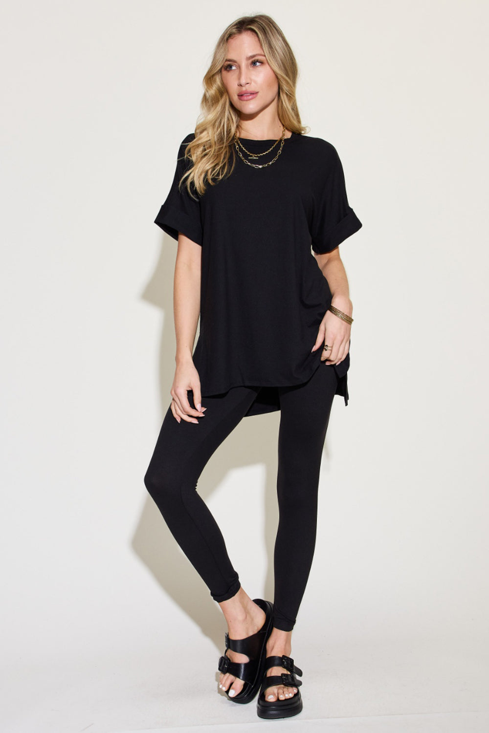 Woman wearing a chic short sleeve slit t-shirt and leggings lounge set, perfect for comfort and style, ideal for both lounging and errands.