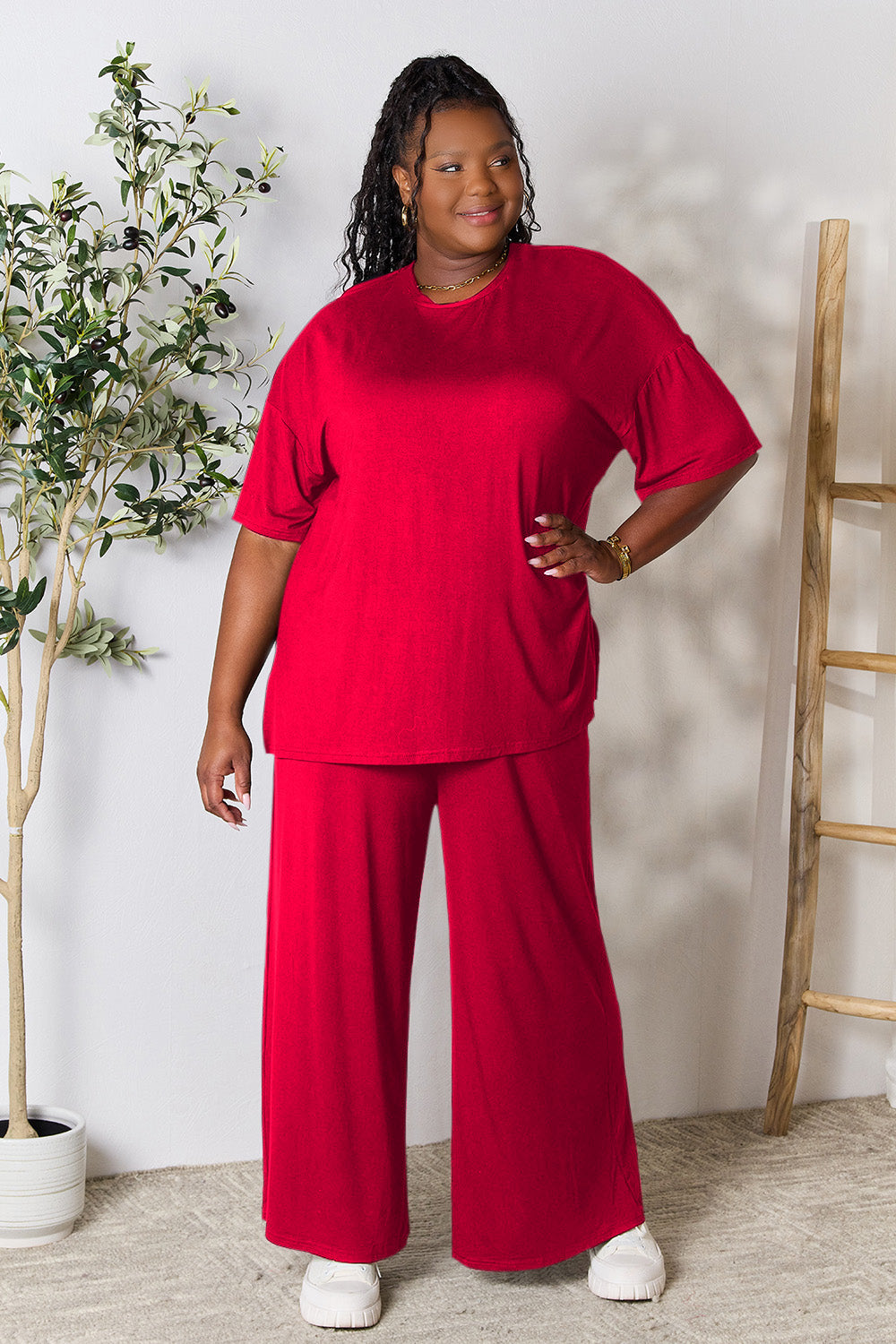 Woman wearing trendy red round neck slit top and pants set for day-to-night transition