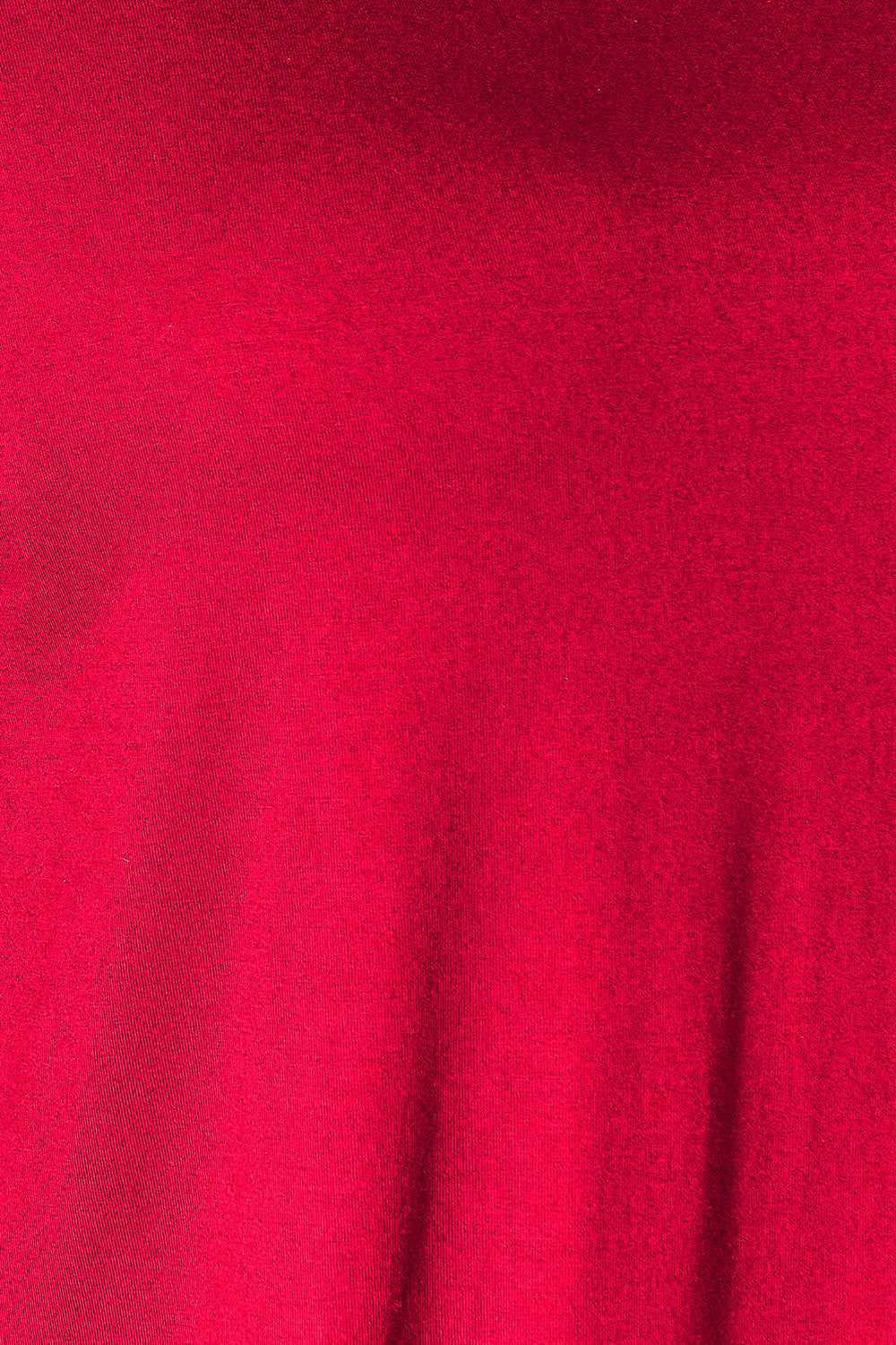 Close-up of red fabric texture from Double Take Round Neck Slit Top, showcasing soft and stretchy rayon-spandex blend.