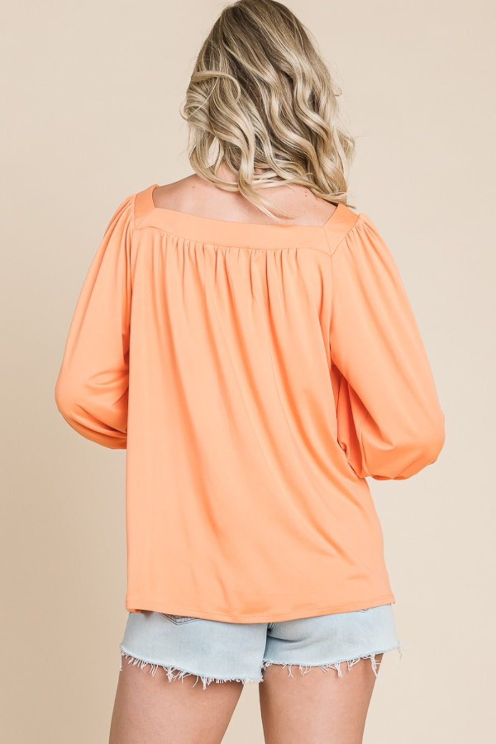 Square Neck Puff Sleeve Top in peach, featuring a chic back view, paired with light denim shorts for a stylish casual look.