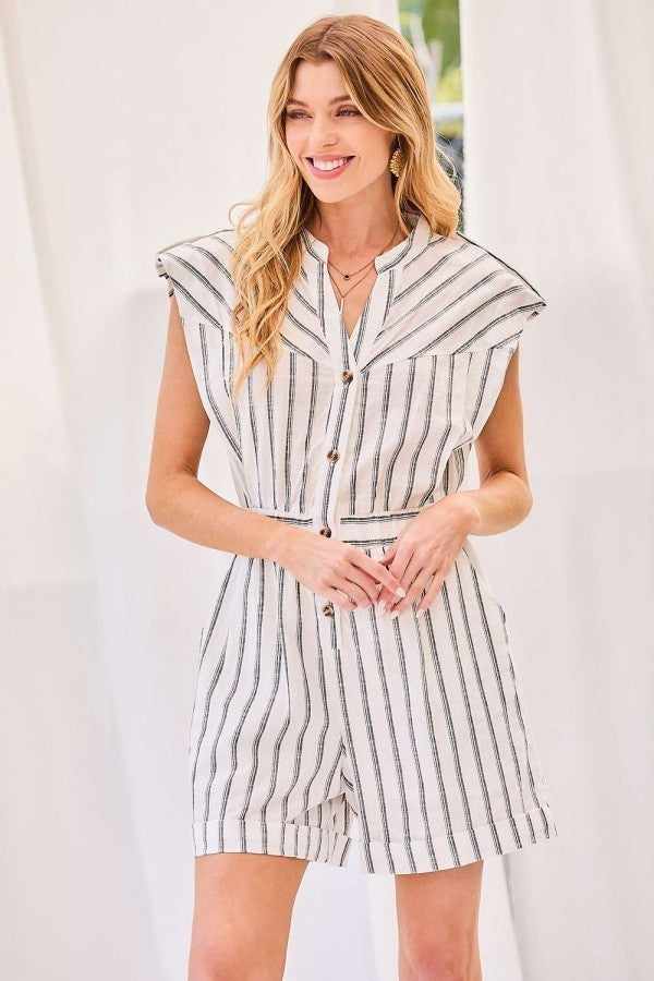 Woman wearing off white notched neck button romper with elastic waist and stripe print, made of 100% rayon.