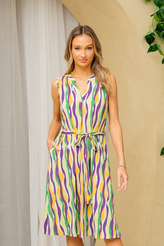 Woman wearing Sew In Love sleeveless stripe dress with tie detail and side pockets, chic semi-sheer fabric, versatile summer style.