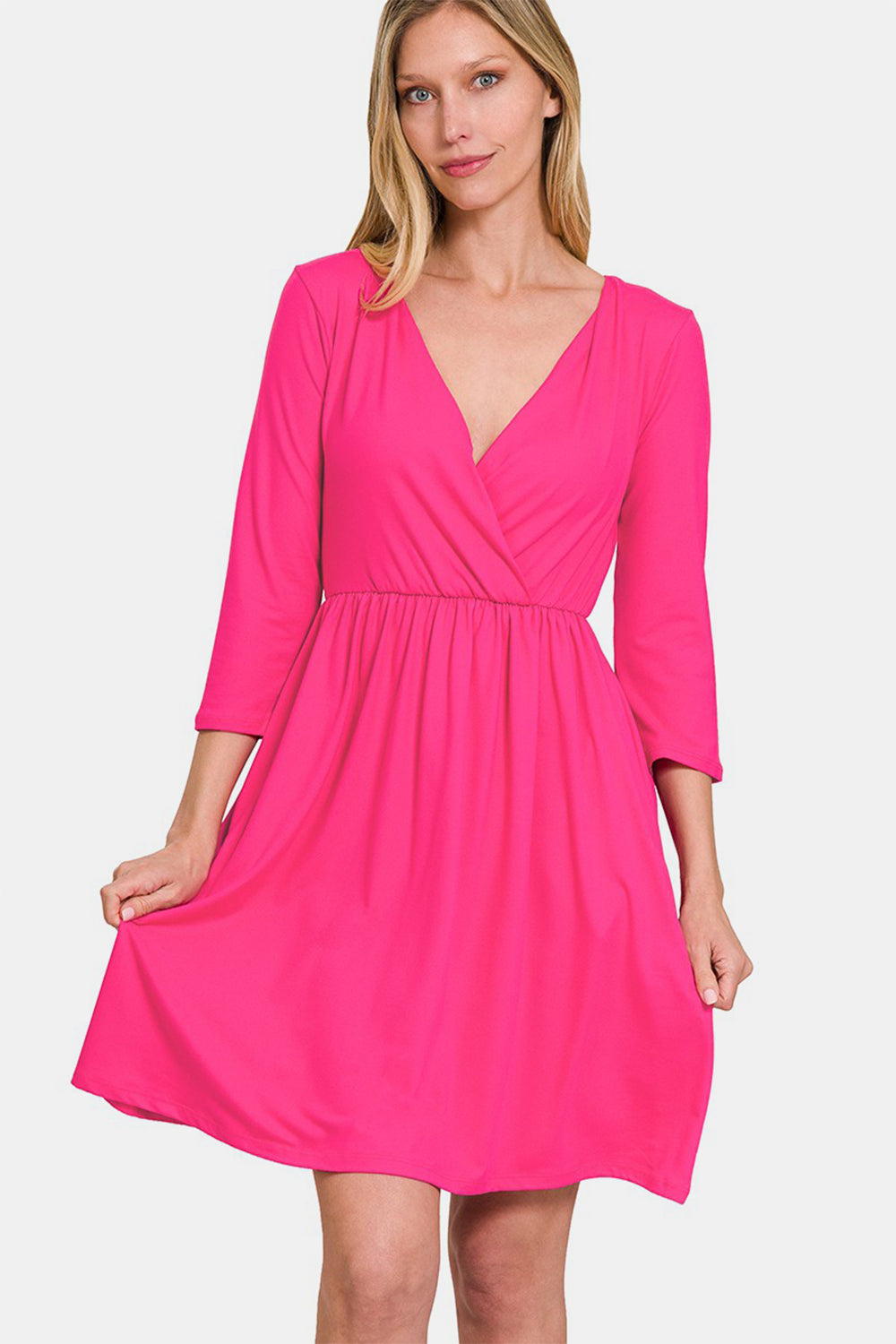 Pink three-quarter sleeve surplice dress with pockets and chic neckline, perfect for versatile day or night occasions.