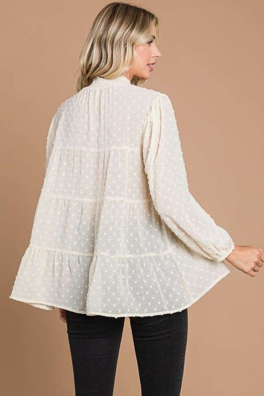 Woman wearing a Swiss Dot Smocked Mock Neck Blouse, back view showcasing the full-size design and breathable polyester fabric.