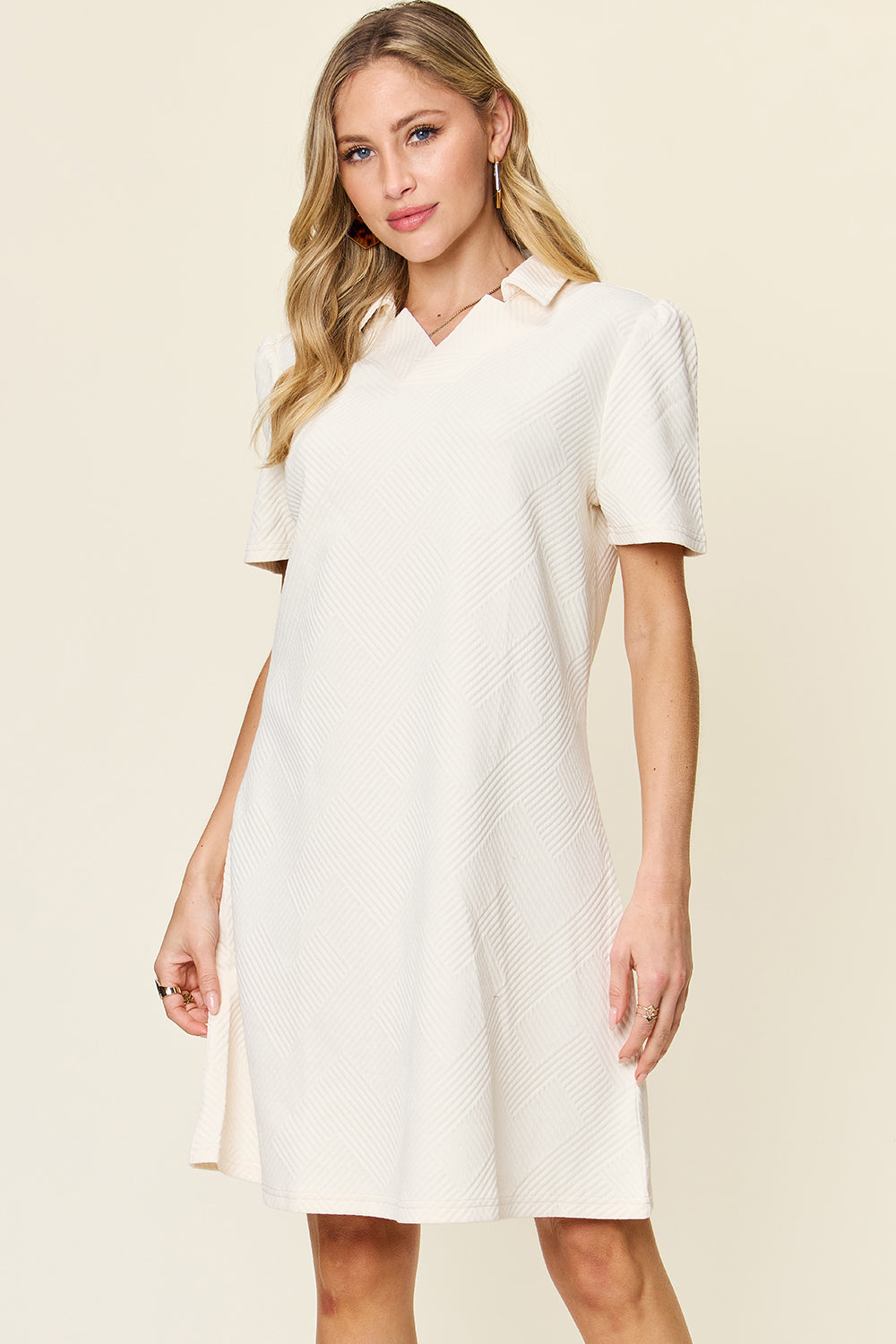 Woman wearing a texture collared neck short sleeve dress with a basic style, made from polyester and spandex, slightly stretchy fabric.