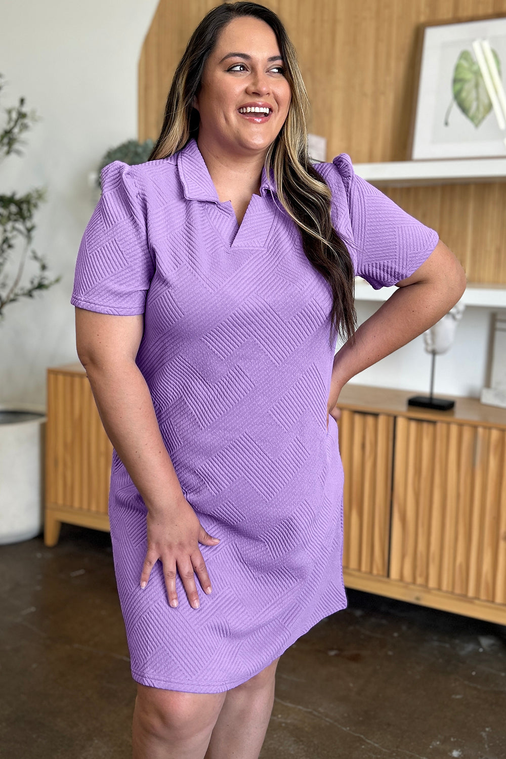 Woman wearing a purple texture collared neck short sleeve dress, featuring a basic style with slightly stretchy fabric.