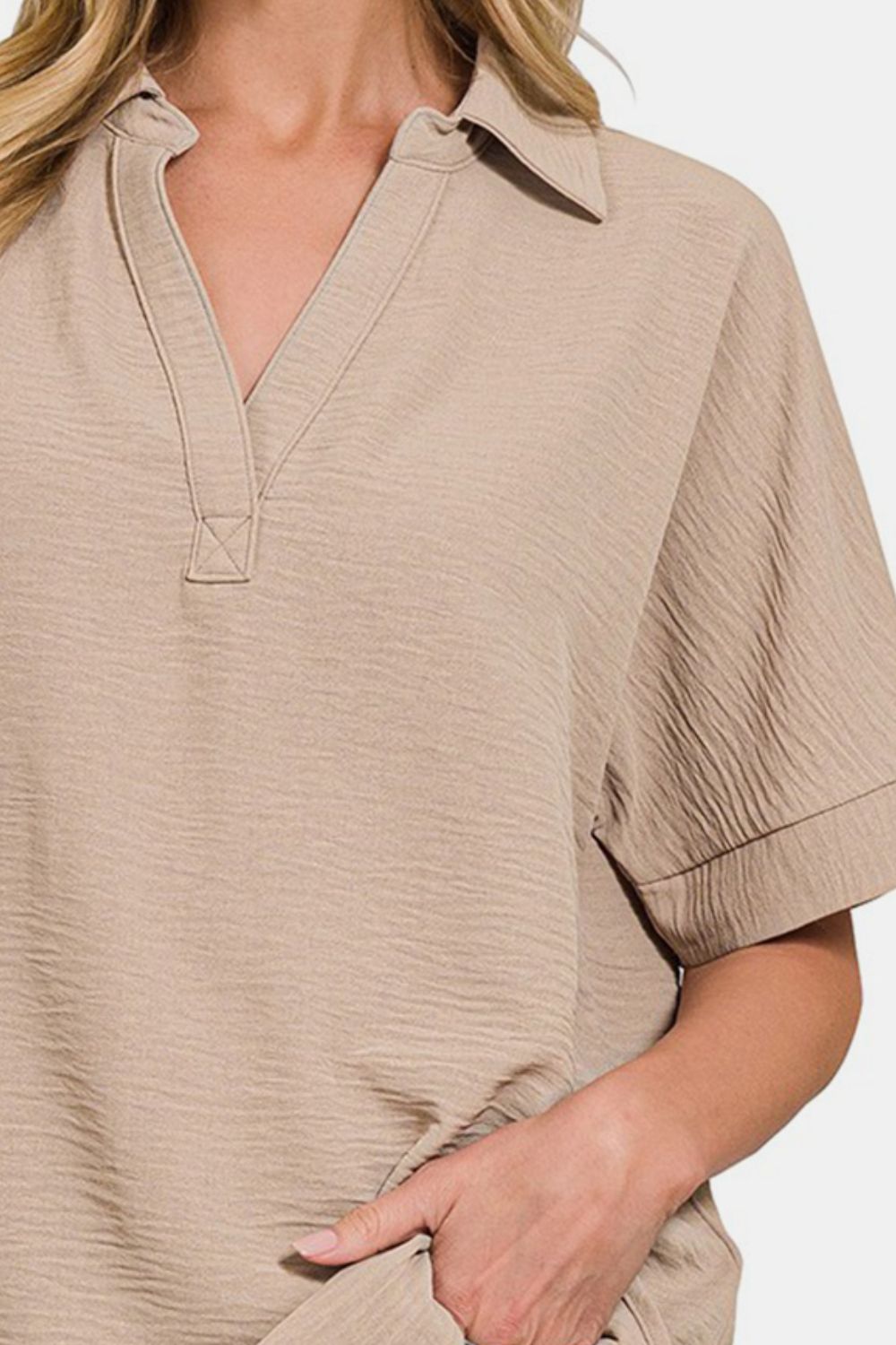 Beige textured collared neck short sleeve top with stylish design and comfortable fit, perfect for casual or dressy occasions.