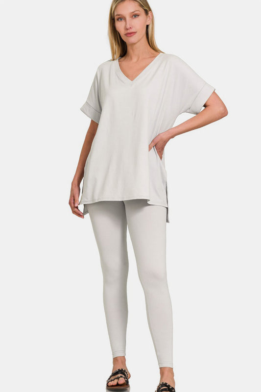 Woman wearing a V-neck rolled short sleeve T-shirt and leggings lounge set, perfect for casual wear or lounging at home.