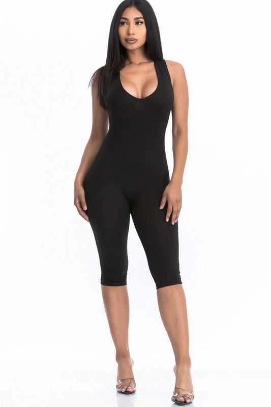 Woman wearing a black racer back capri jumpsuit with a sleeveless design, showcasing a chic summer fashion trend.