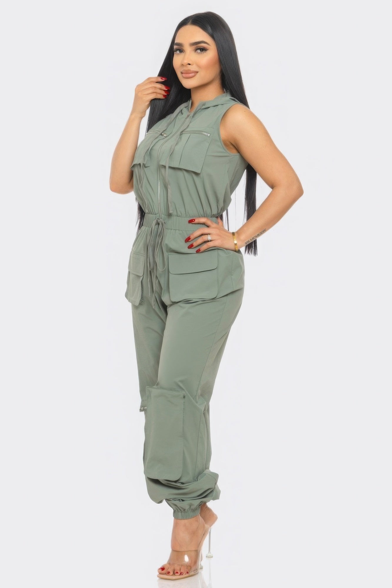 Chic women's cargo jumpsuit in green with utility design, sleeveless style, and relaxed fit. Fashionable one-piece ensemble.