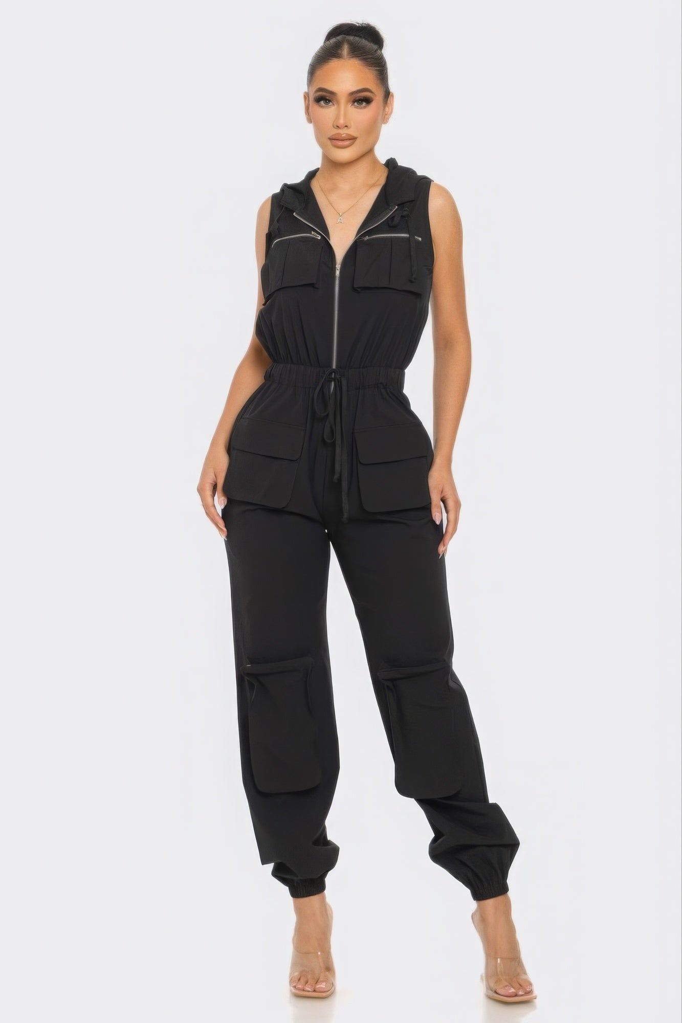 Chic women's Tracy cargo jumpsuit in black, featuring a hoodie and utility pockets, perfect for stylish all-day comfort.