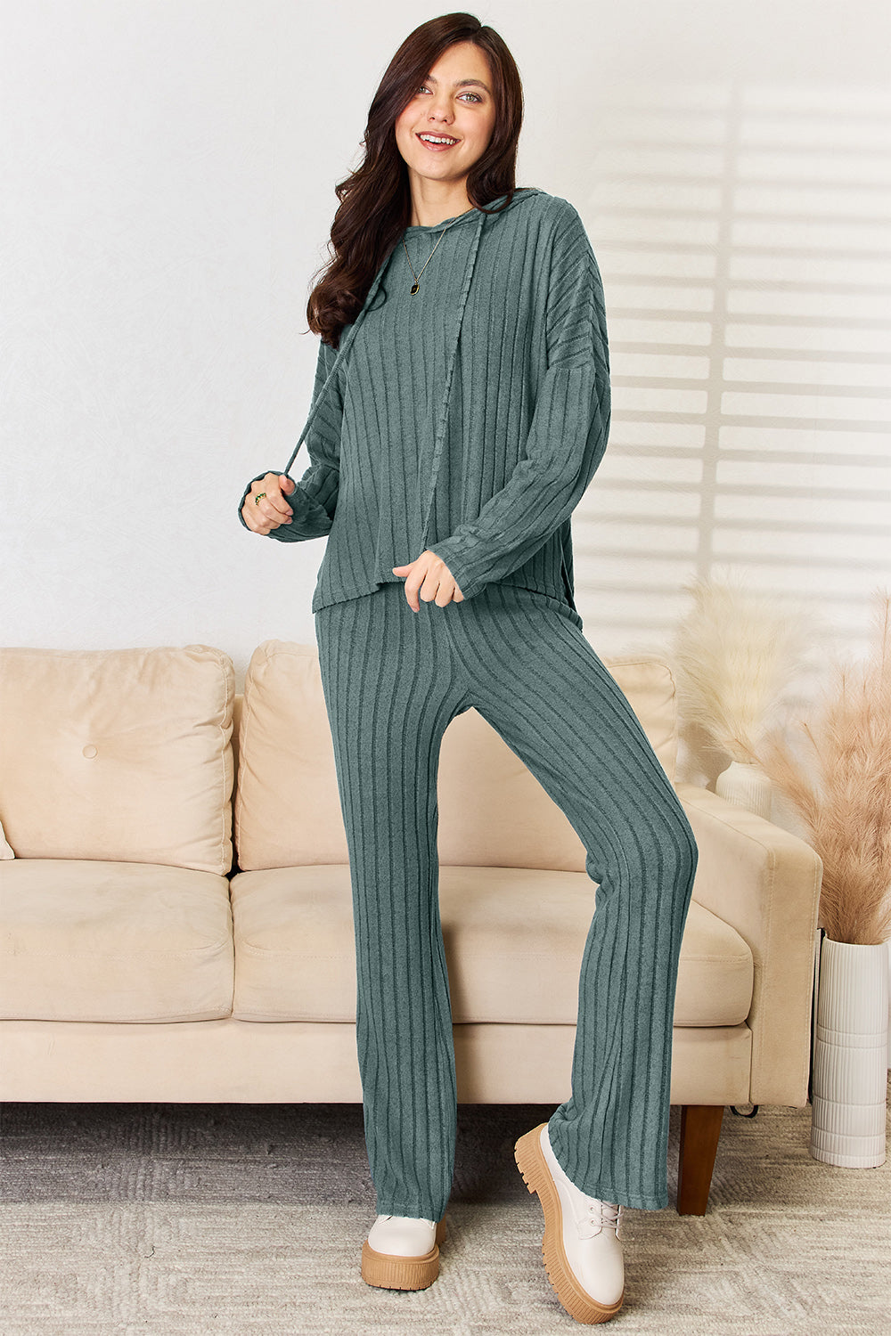 Woman wearing ribbed Chill Day hooded top and straight pants set with drawstring, made of slightly stretchy polyester-elastane.