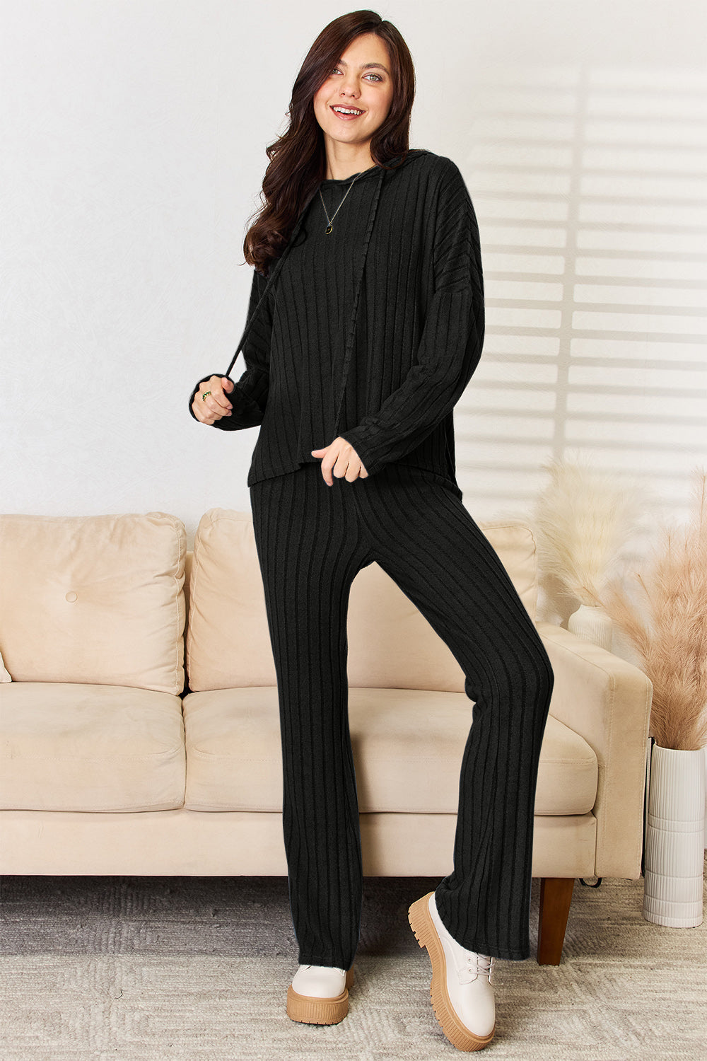 Woman wearing black Chill Day Hooded Top and Straight Pants Set with drawstring, ribbed texture, slightly stretchy fabric.