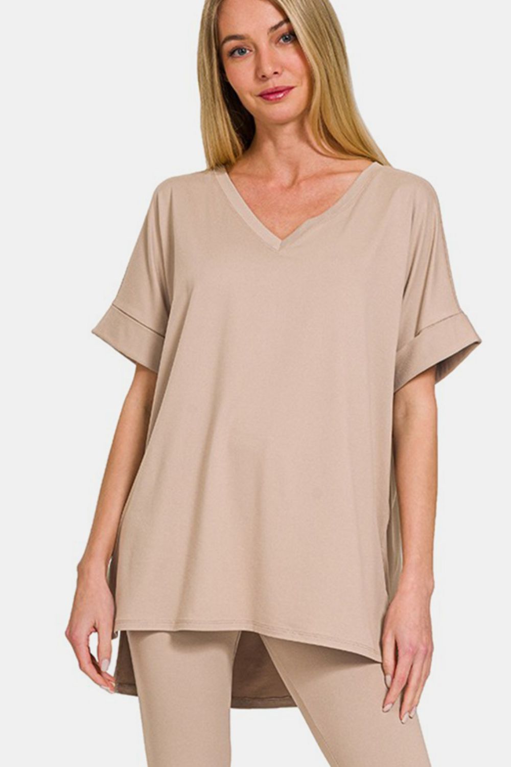 Woman wearing a beige V-neck rolled short sleeve T-shirt and leggings lounge set, perfect for comfort and style.