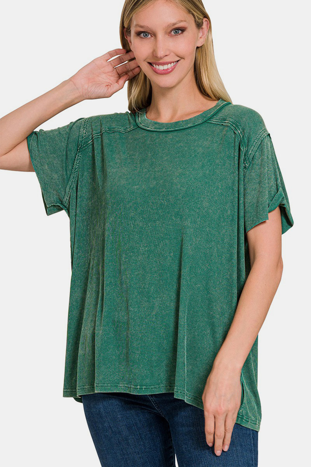 Woman wearing a green washed ribbed short sleeve top with moderate stretch, made of 93% rayon and 7% spandex.