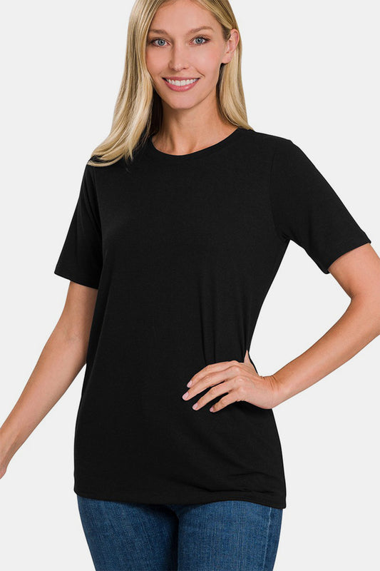 Woman wearing a black cozy crew neck short sleeve T-shirt, made from a polyester, rayon, and spandex blend with a slightly stretchy fit.