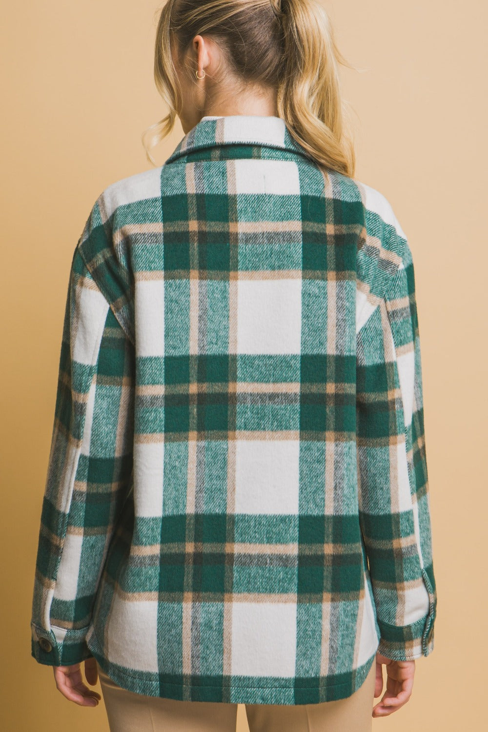 Back view of a green plaid button-up shacket with pockets, made of 100% polyester, unlined, normal thickness.