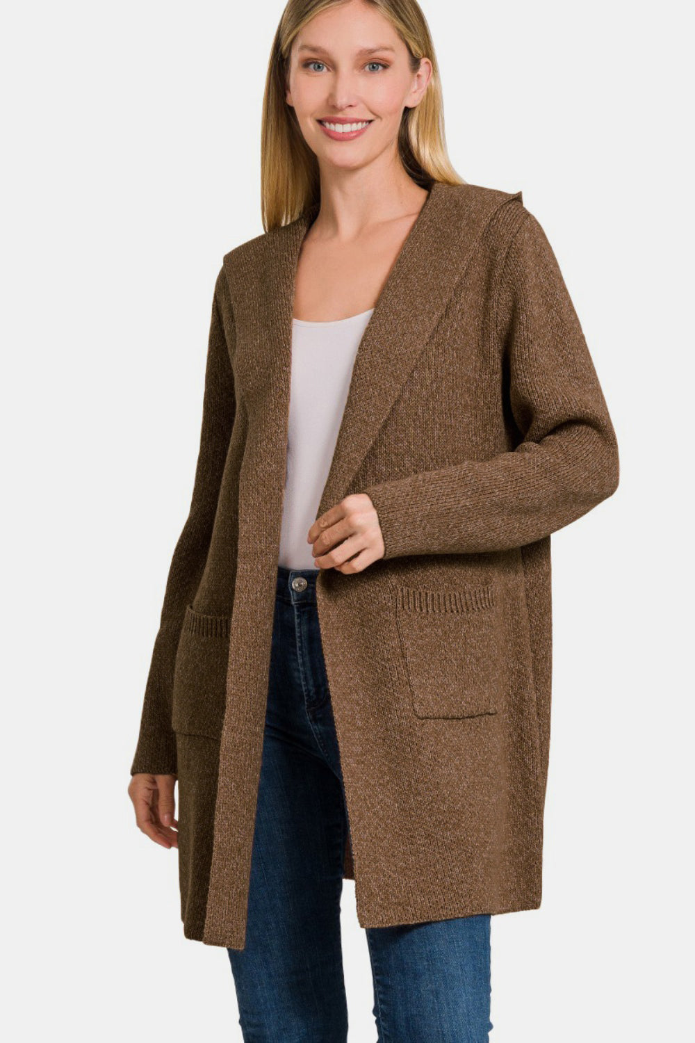 Woman wearing a cozy hooded open front sweater cardigan with front pockets for a casual and stylish look.