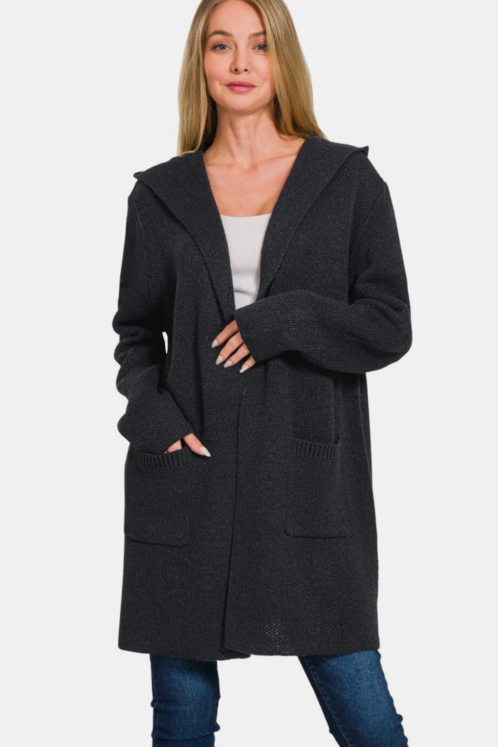 Woman wearing cozy hooded open front sweater cardigan with pockets, perfect for layering over casual outfits.