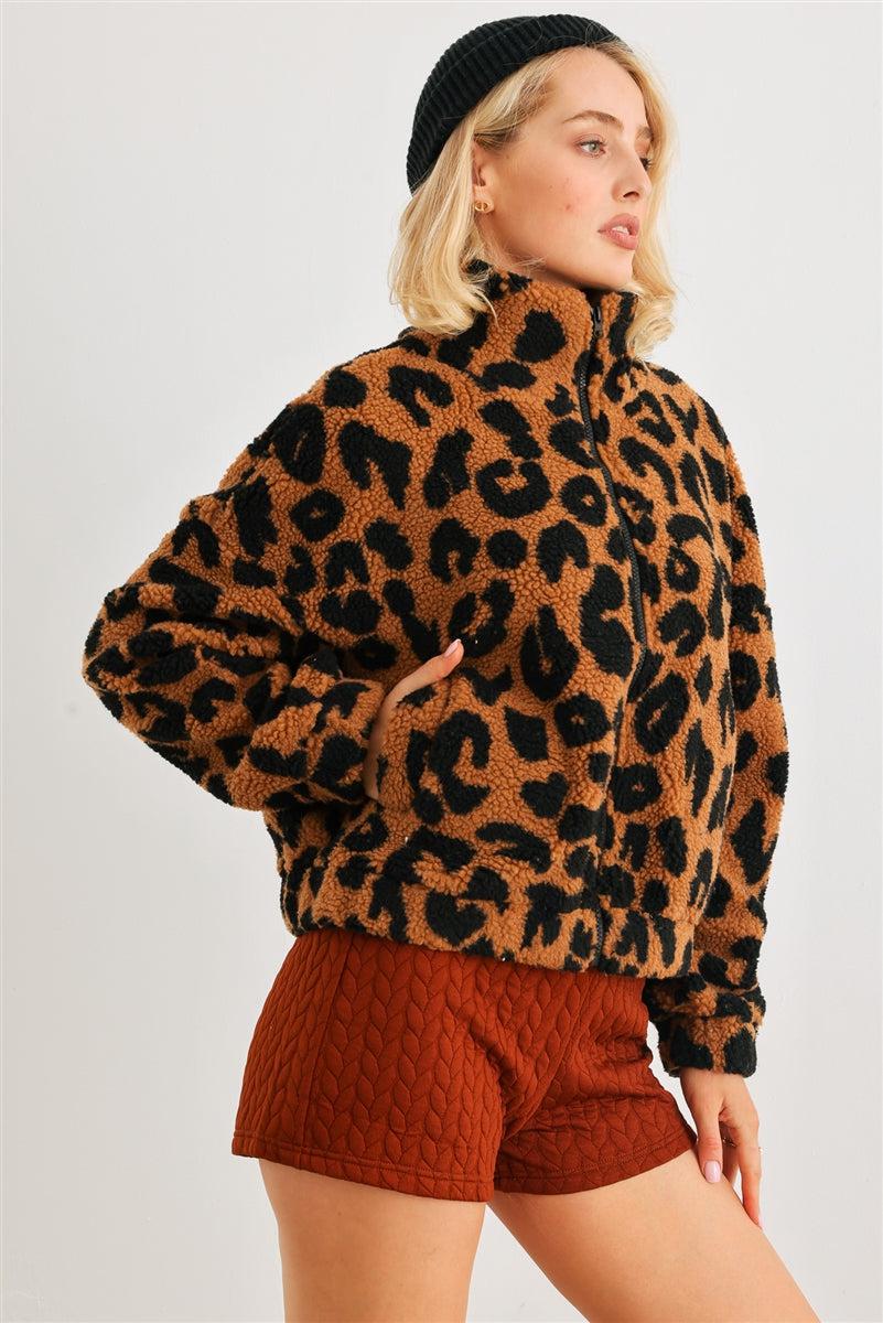 Woman wearing leopard print teddy jacket with turtle neckline and pockets, cozy and stylish for casual wear.