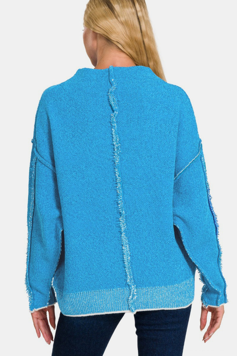 Blue cozy exposed seam mock neck sweater with long sleeves, slightly stretchy material, polyester-acrylic blend.