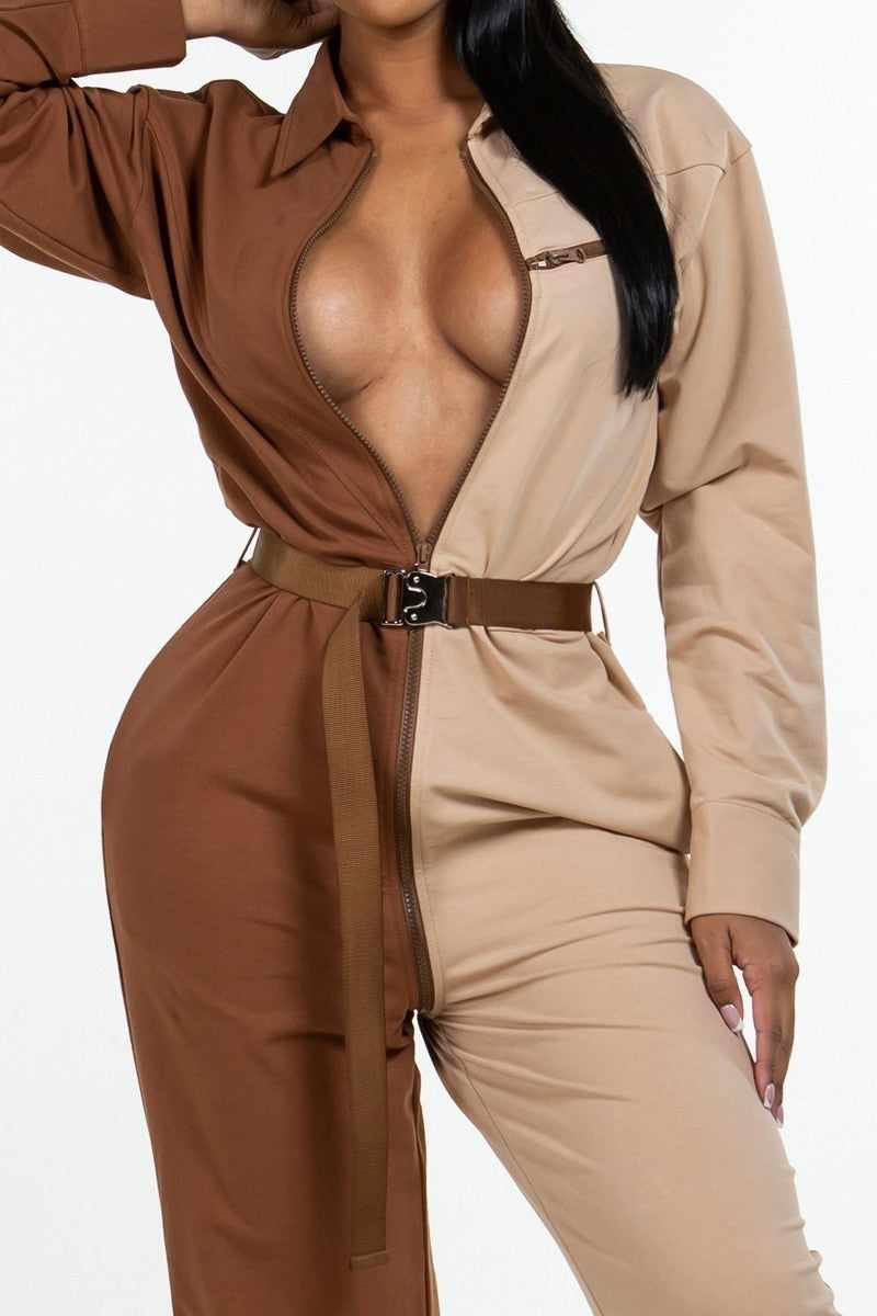 Brown long sleeve oversized shirt jumpsuit with accent belt and adjustable front zipper, made from polyester and cotton blend.