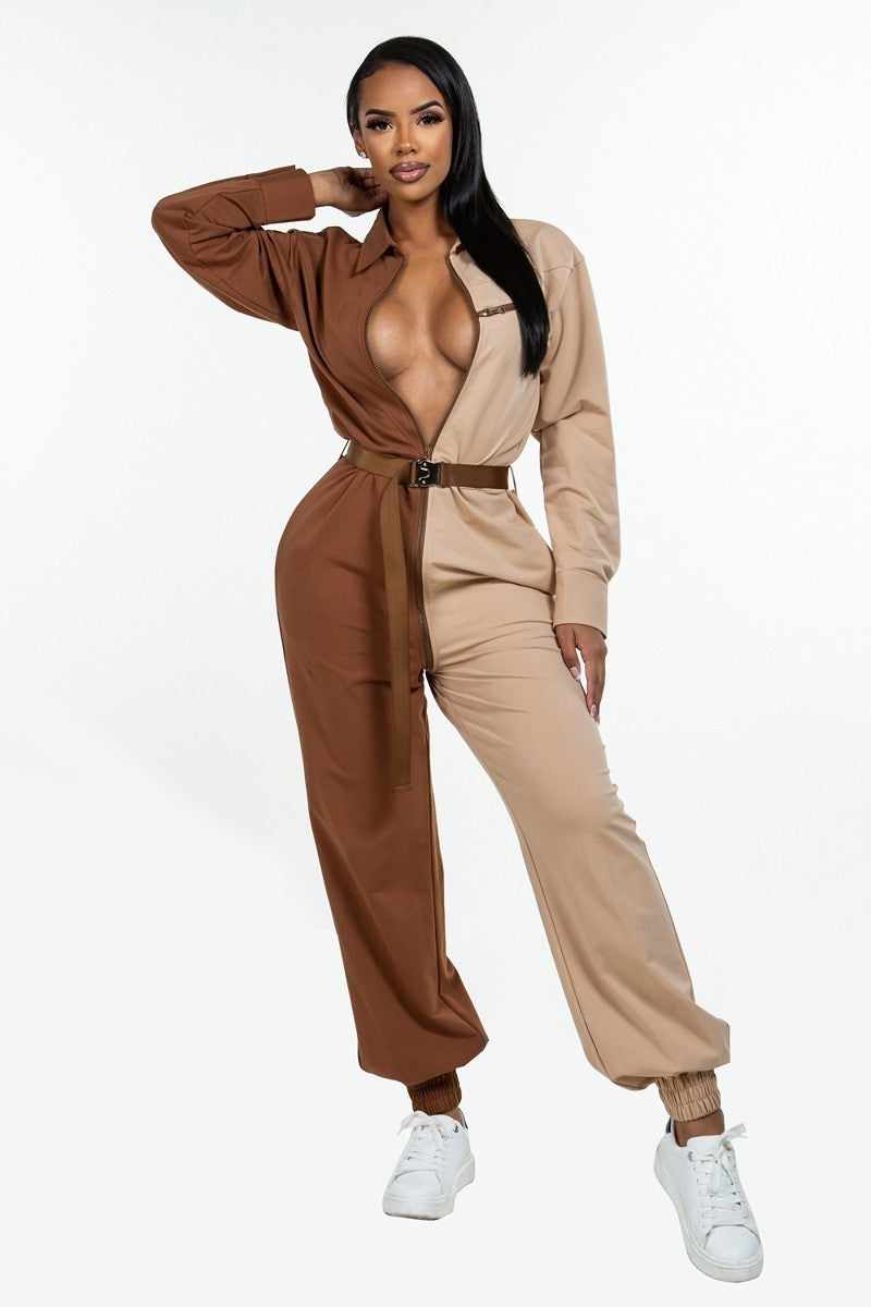 Woman wearing a brown and beige long sleeve oversized cozy shirt jumpsuit with an accent belt and adjustable front zipper.