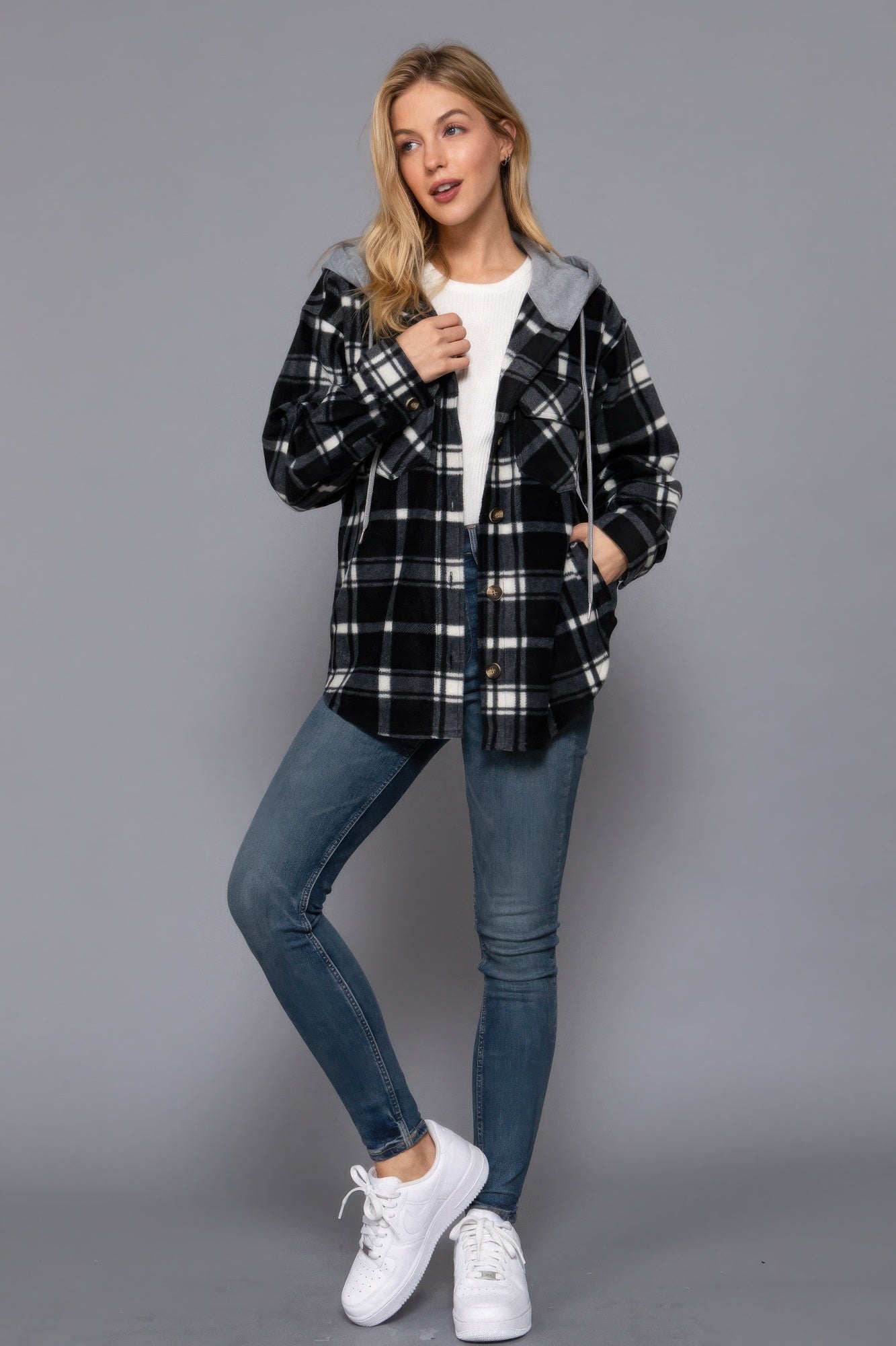 Woman wearing ivory/navy plaid print fleece hoodie jacket, perfect for casual outings and cool weather comfort.