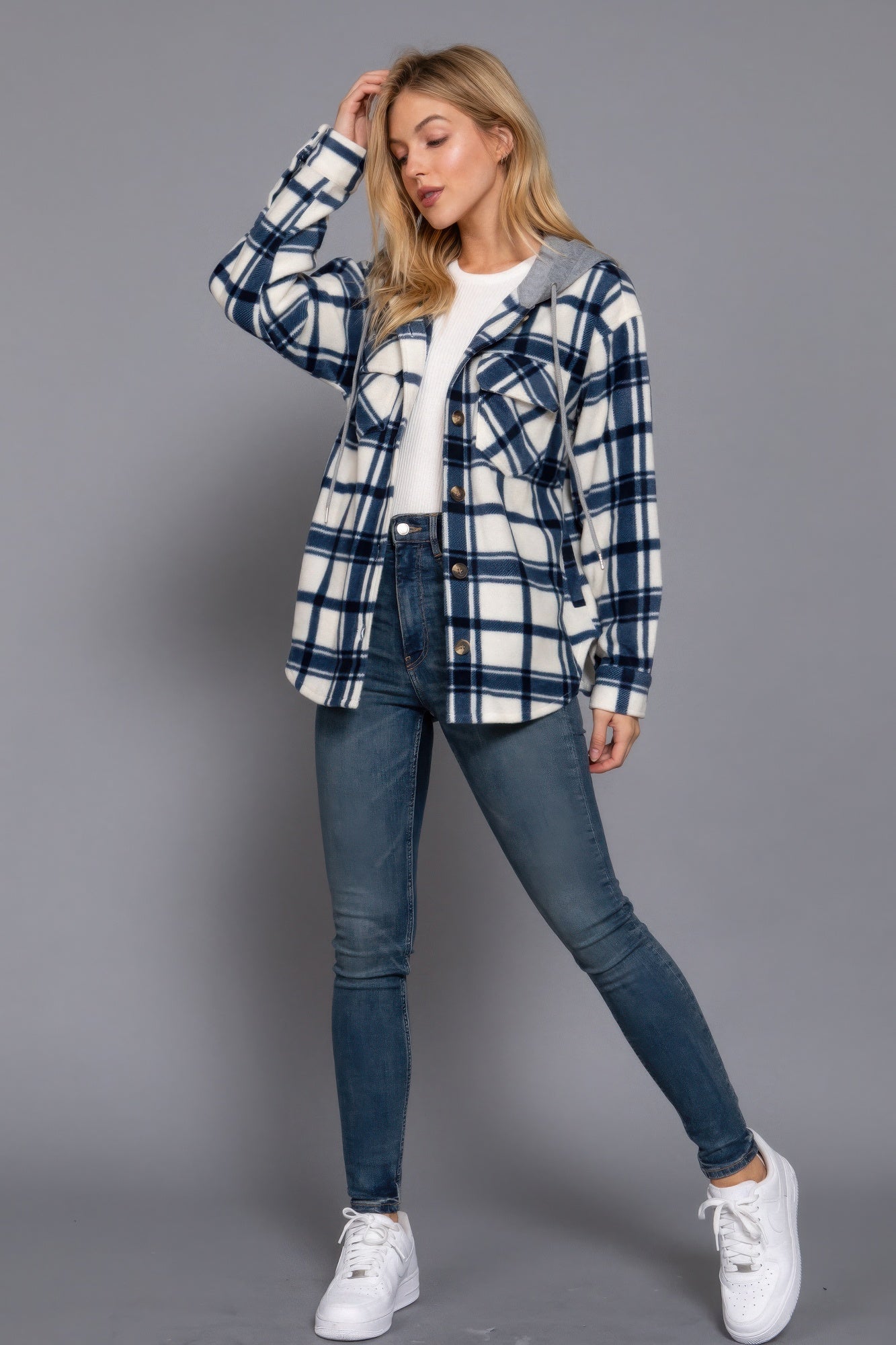 Ivory and navy plaid print fleece hoodie jacket with front button-down closure, modeled with casual jeans and white sneakers.