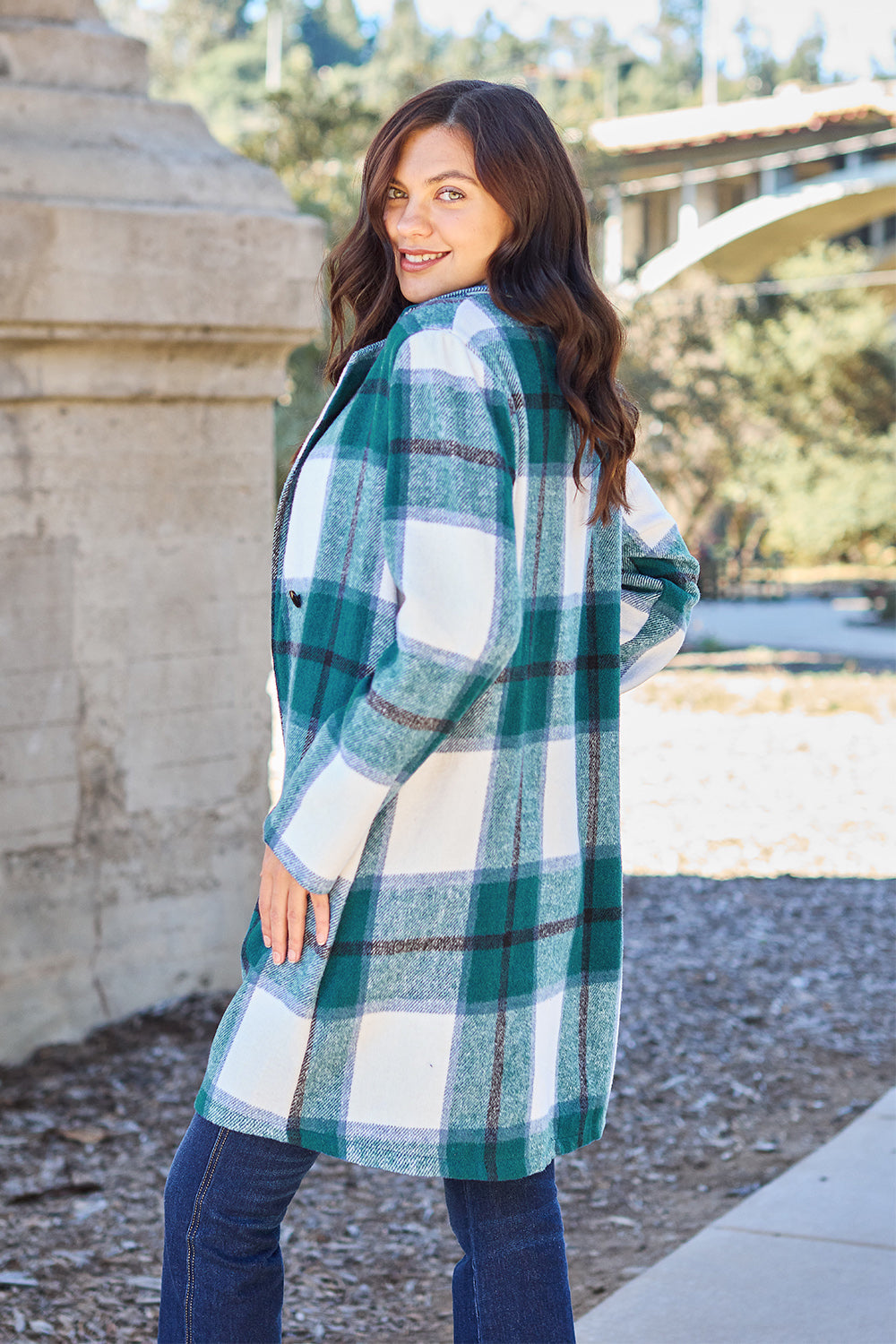 Woman wearing a full-size plaid button-up coat with lapel collar, side pocket, green and white pattern, made from 100% polyester.