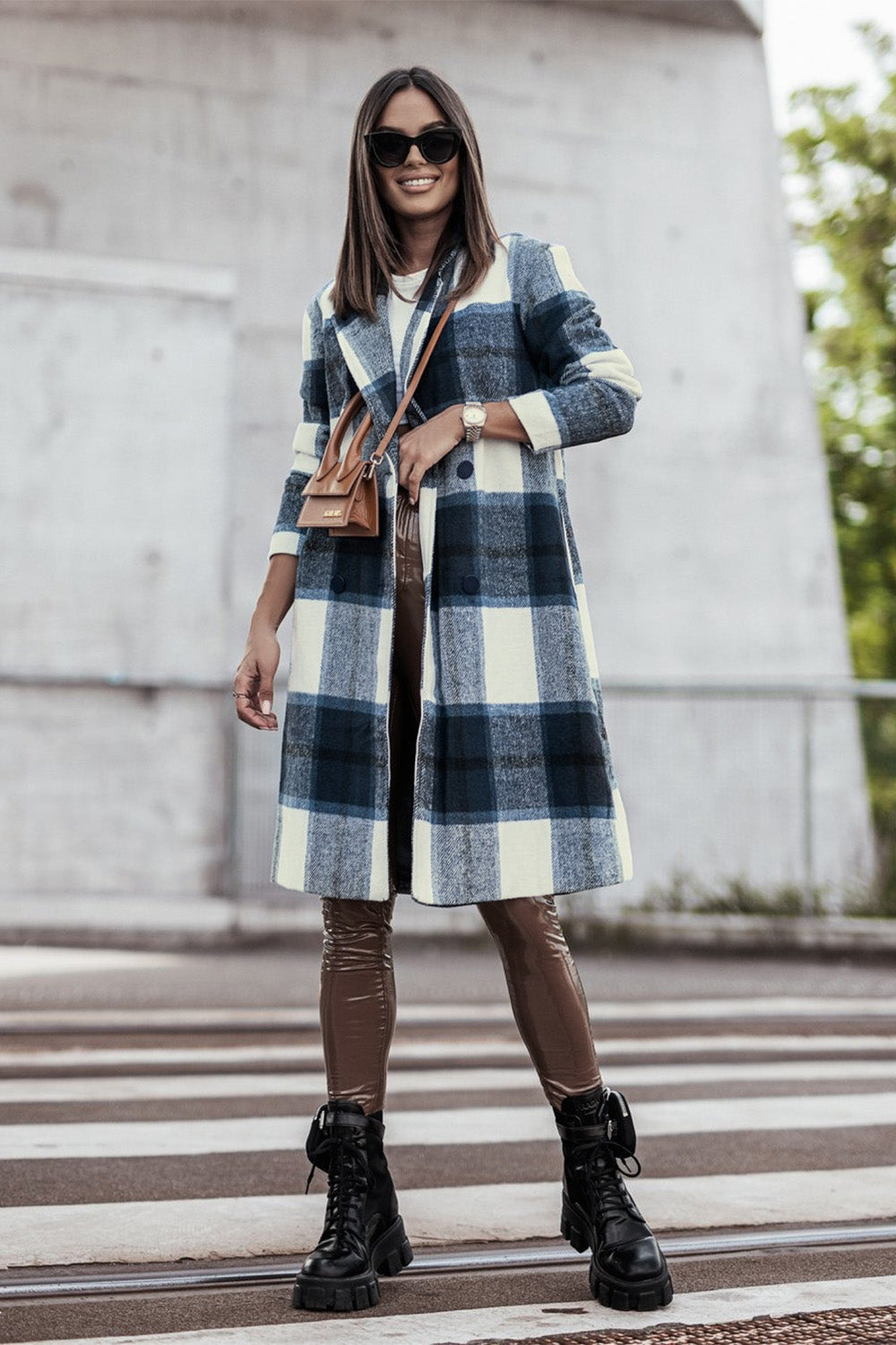 Woman wearing a stylish full-size plaid button-up lapel coat with pockets, made from 100% polyester, perfect for casual outings.