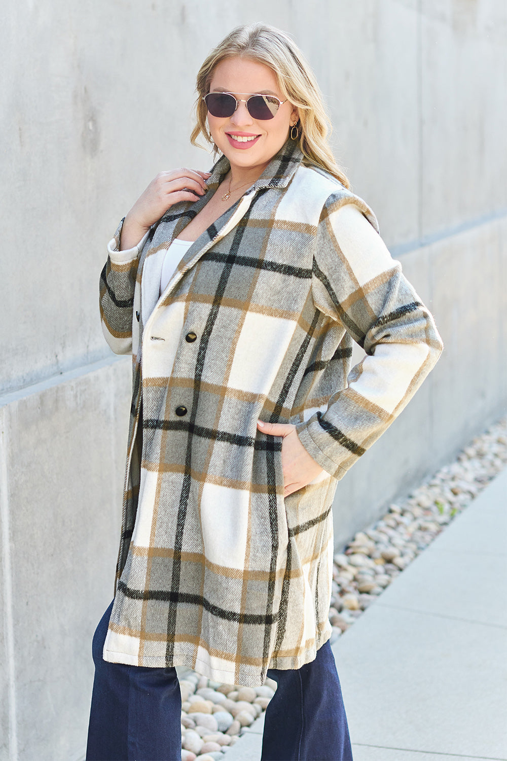 Woman wearing full-size plaid button-up lapel collar coat with pockets, perfect for stylish and cozy fall outfits.