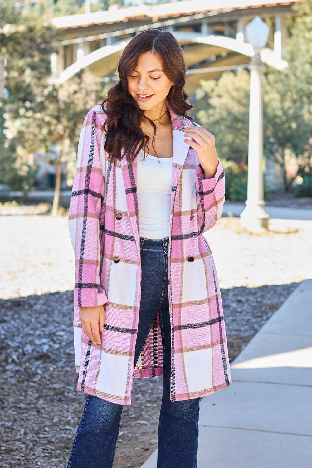 Woman wearing full-size plaid button-up lapel collar coat with pockets, outdoor setting. 100% polyester, casual fashion.