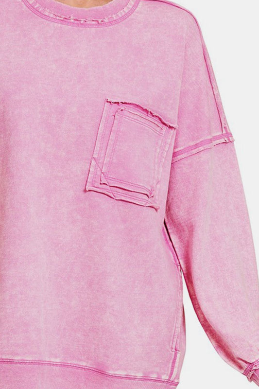 Pink round neck dropped shoulder sweatshirt with exposed seams and front pocket, made from 100% cotton with moderate stretch.