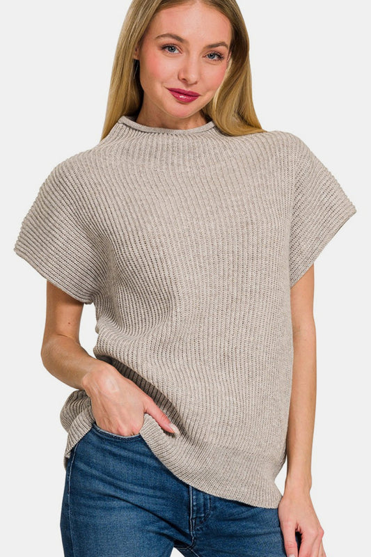 Woman wearing short sleeve mock neck sweater, slightly stretchy fabric, 50% polyester and 50% acrylic, casual style.