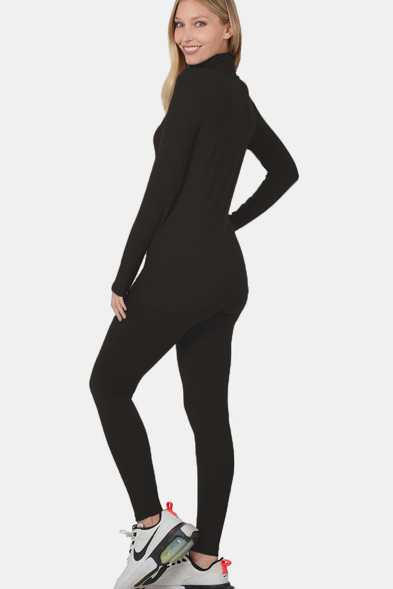 Woman wearing black turtleneck top and leggings lounge set with sneakers, showcasing a chic and versatile fashion style.