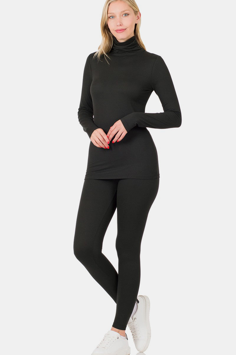 Woman wearing black turtleneck top and leggings lounge set with white sneakers