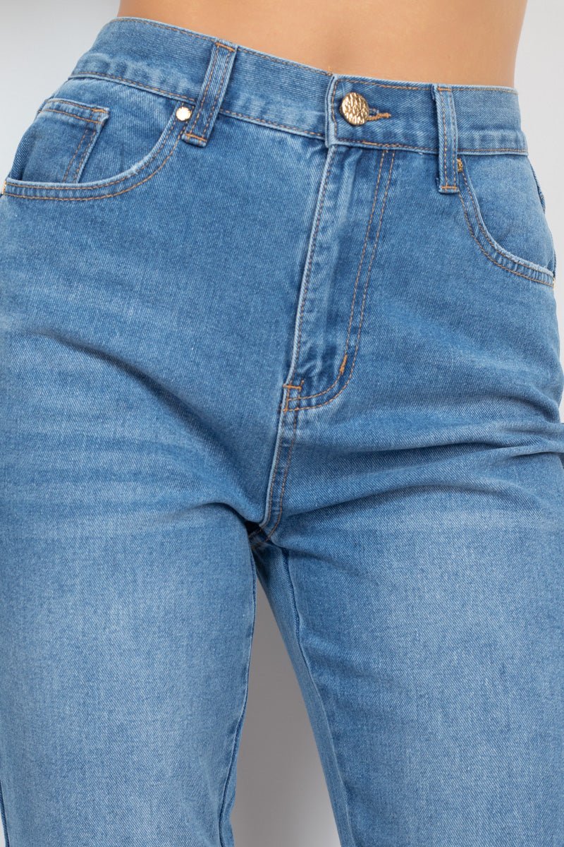 High-rise medium denim mom jeans with zip-fly button and five-pocket design featuring a cuffed-button hem detail.
