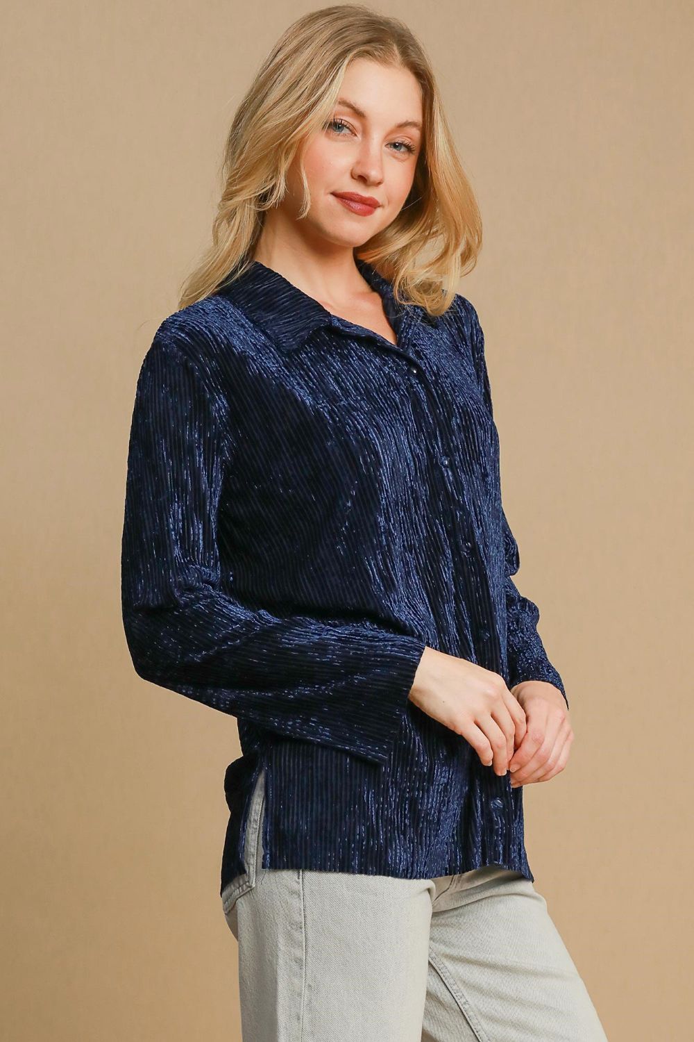 Woman wearing navy side slit texture button-up shirt, slightly stretchy fabric, composed of 95% polyester and 5% spandex.