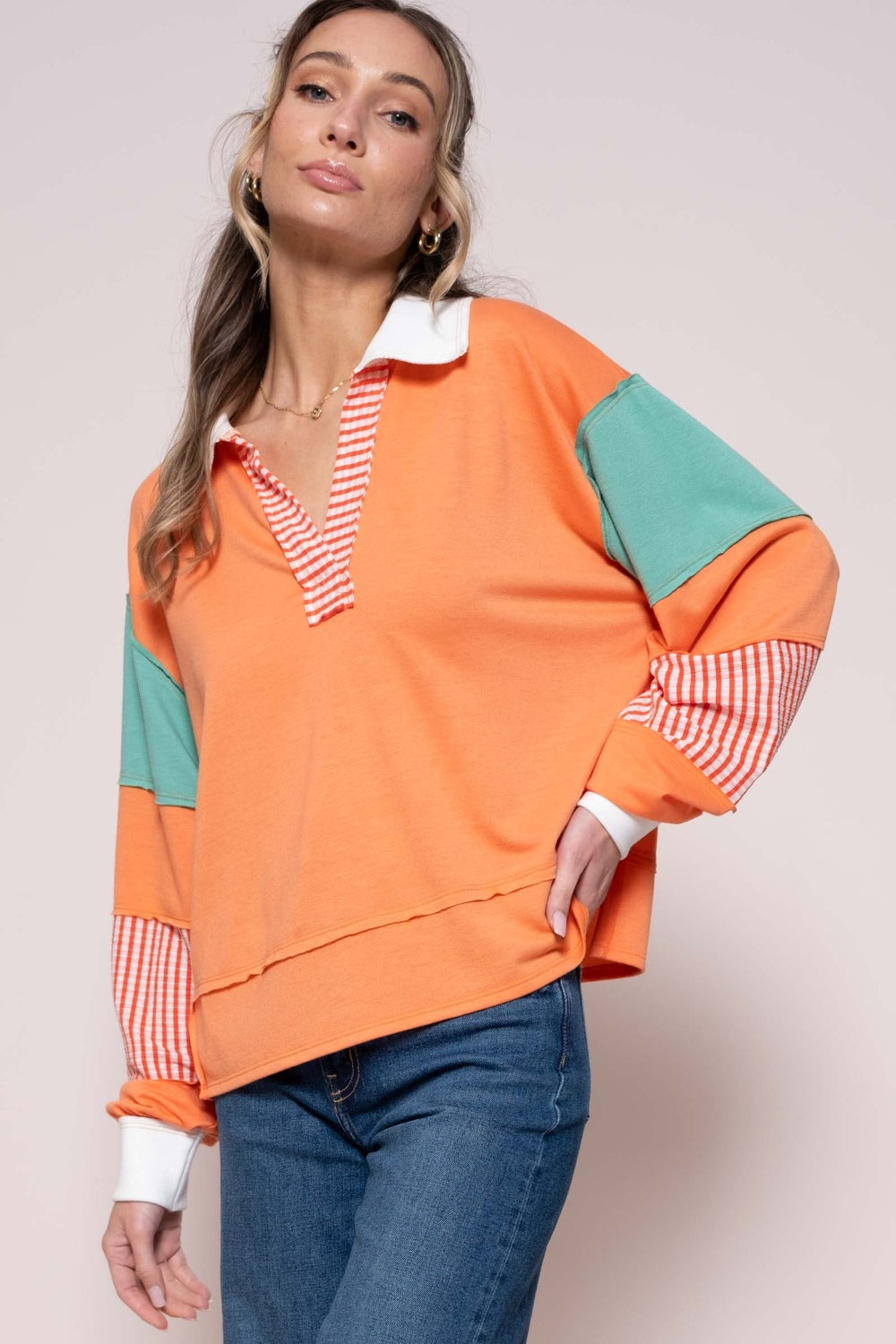 Stylish coral color block top with striped panel, featuring a basic opaque design made of polyester, rayon, and spandex.