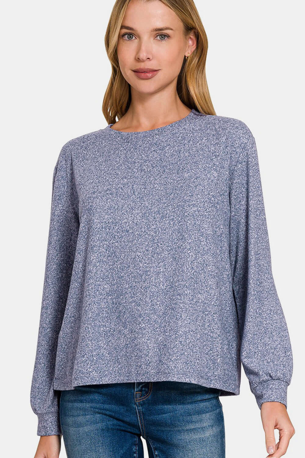 Woman wearing light navy hacci round neck long sleeve t-shirt with jeans.