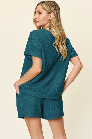 Stylish woman modeling teal Darling Texture short sleeve t-shirt and drawstring shorts set with pockets, stretchy polyester-spandex blend