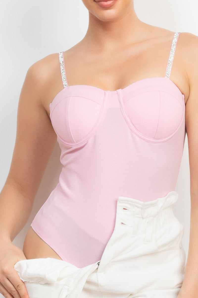 Pink rhinestone trim bustier cami bodysuit with sweetheart neckline and padded cups, styled with adjustable straps.