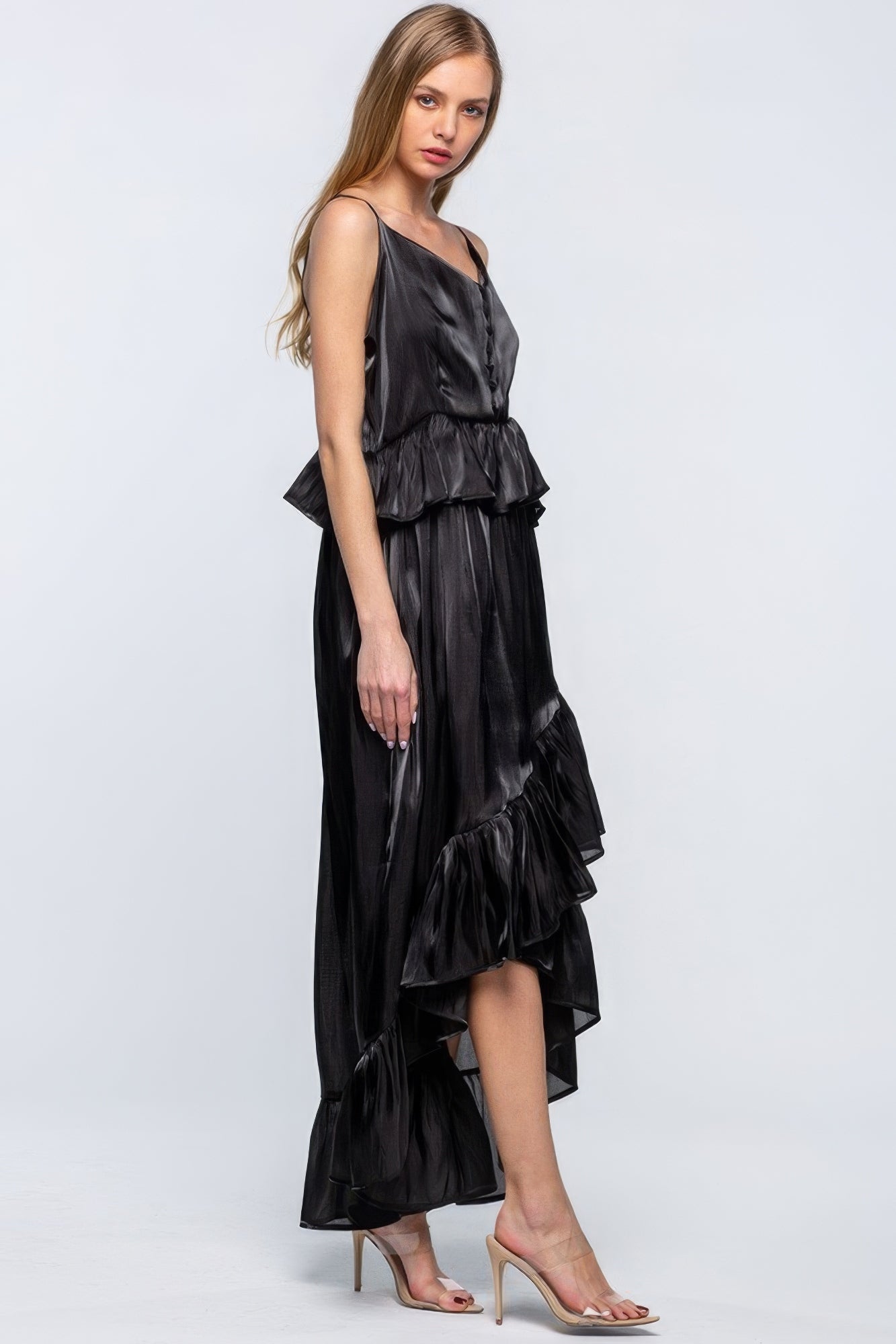 Shimmering sleeveless dress with ruffles, adjustable straps, and asymmetric hemline, perfect for special occasions.