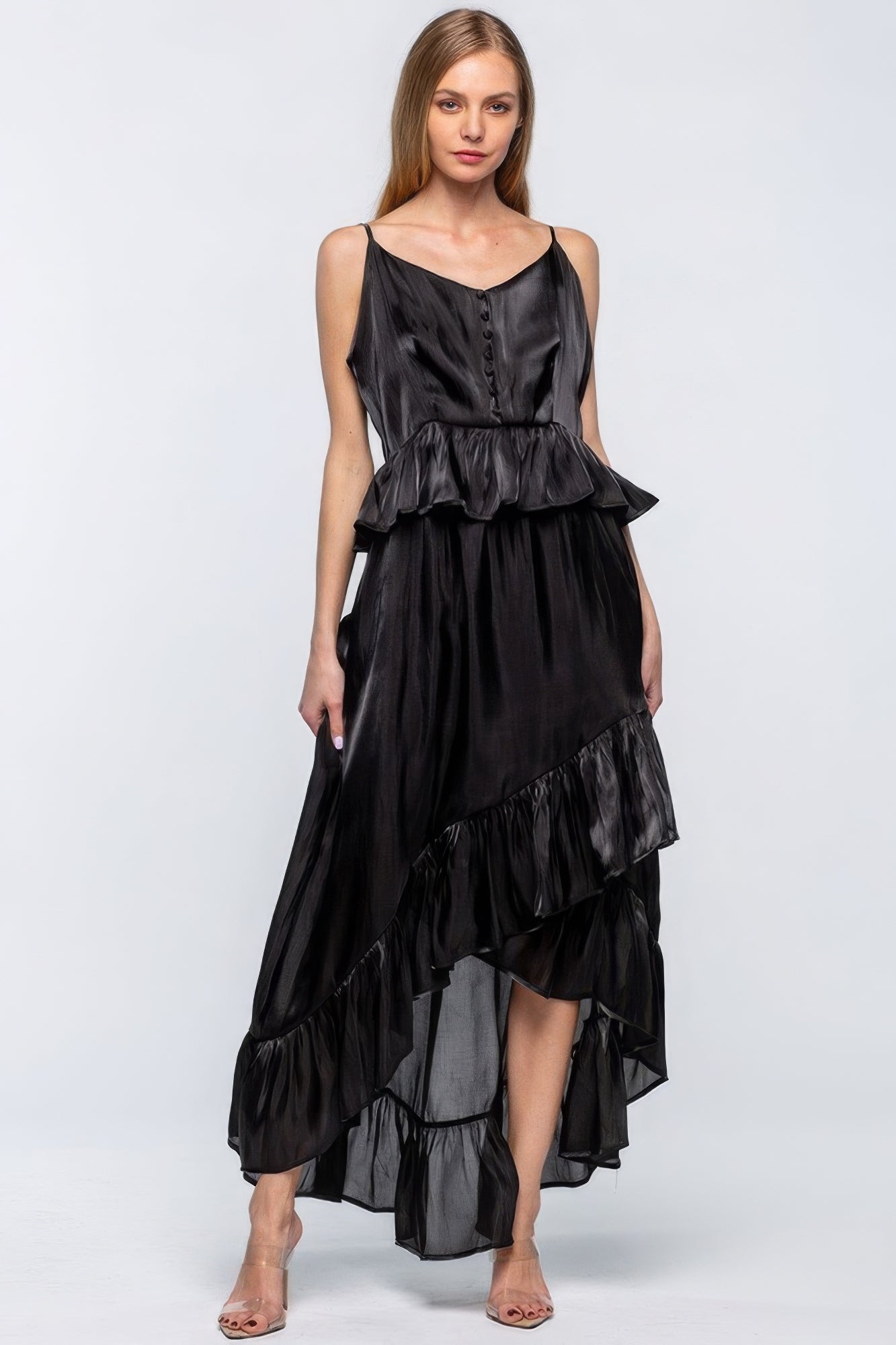 Elegant sleeveless black shimmering dress with asymmetric ruffles, featuring adjustable straps and an eye-catching hemline, perfect for special occasions.