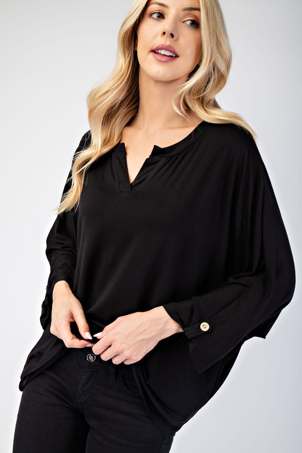 Black full-size notched three-quarter sleeve blouse, slightly stretchy, made of 96% rayon and 4% spandex, worn by a model.